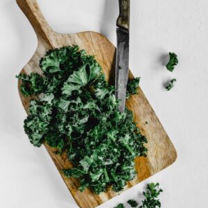 Close-Up Shot of Chopped Kale on a Wooden Chopping Board