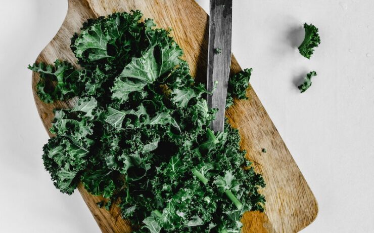 Close-Up Shot of Chopped Kale on a Wooden Chopping Board