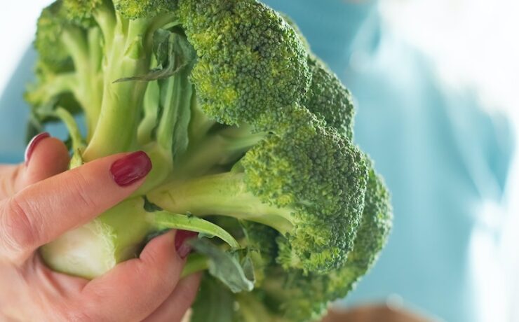 foto della donna che tiene i broccoli cucina sacchetto