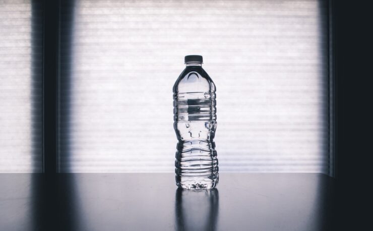 Clear Disposable Bottle on Black Surface