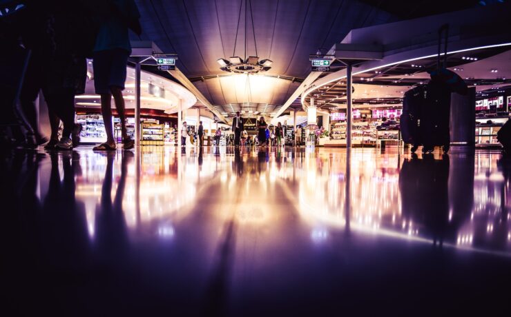 people standing on lighted room duty free airport