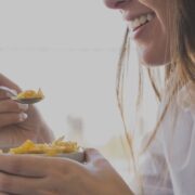 woman eating oaks breakfast while smiling