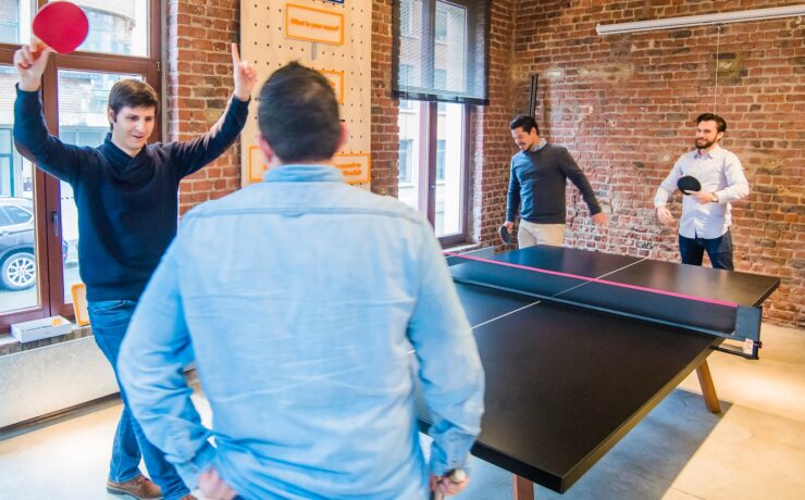 four men playing table tennis