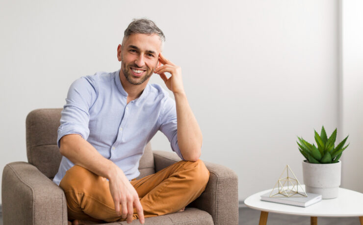 man smiling on the sofa