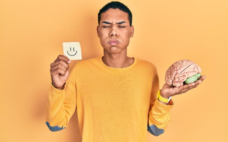 young boy holding his brain in his hand