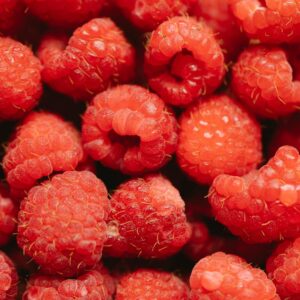 Vibrant close-up of fresh, ripe raspberries showcasing their vivid red color and texture.