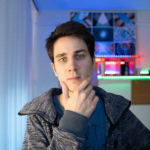 a young man is looking at the camera